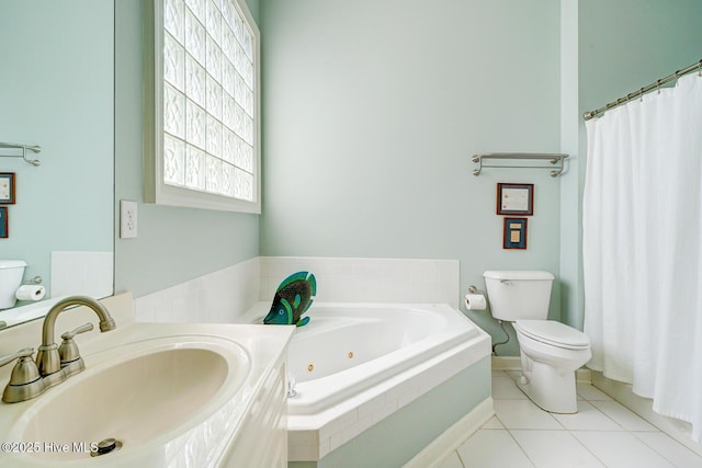 full bathroom featuring toilet, a tub with jets, tile patterned flooring, and vanity