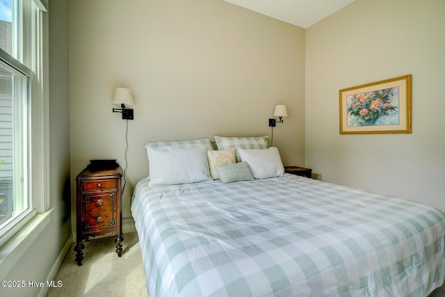 carpeted bedroom featuring baseboards
