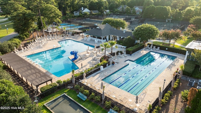 community pool with a pergola and a patio