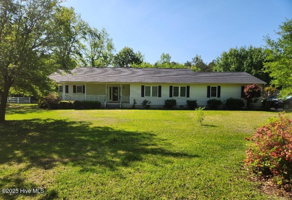 single story home with a front yard, a porch, and crawl space
