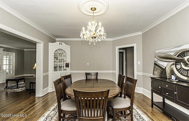 300 Moye Ave NW, Wilson, NC 27893 - dining space with dark wood-type flooring, ornamental molding, and a chandelier