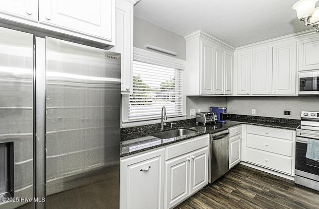 300 Moye Ave NW, Wilson, NC 27893 - kitchen featuring appliances with stainless steel finishes, white cabinets, dark wood-style flooring, and dark stone countertops