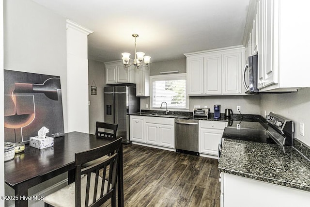 300 Moye Ave NW, Wilson, NC 27893 - kitchen with appliances with stainless steel finishes, dark wood-type flooring, a chandelier, and white cabinets