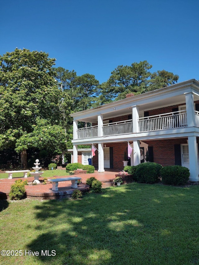 300 Moye Ave NW, Wilson, NC 27893 - view of front of house featuring brick siding, a front yard, and a balcony