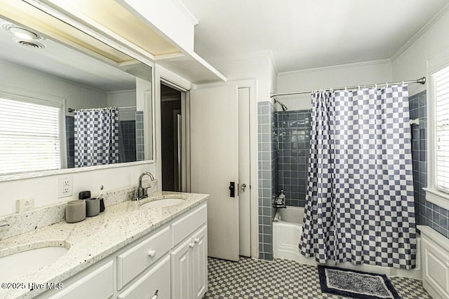 bathroom with double vanity, shower / bath combo with shower curtain, tile patterned floors, and a sink
