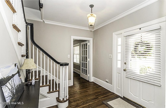 entryway with a wealth of natural light, crown molding, wood finished floors, and stairs