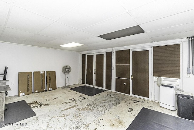 interior space with a paneled ceiling