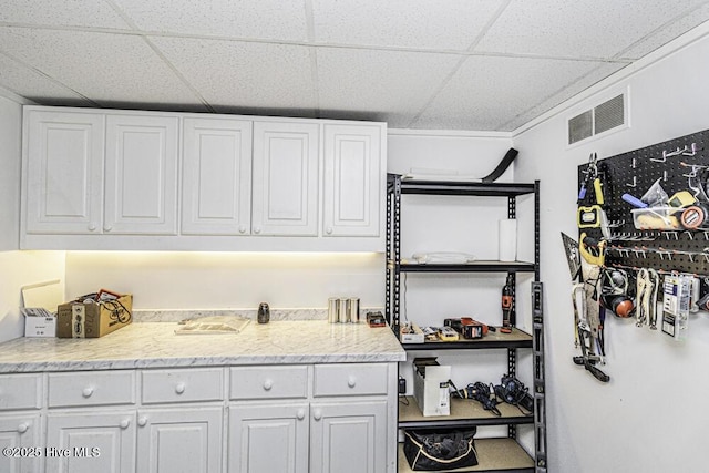 300 Moye Ave NW, Wilson, NC 27893 - kitchen featuring a paneled ceiling, white cabinetry, open shelves, and light stone counters