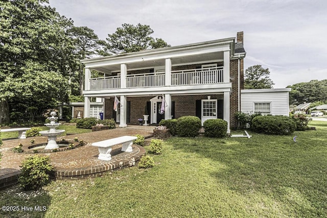 300 Moye Ave NW, Wilson, NC 27893 - view of front of house with a balcony, a front lawn, and brick siding
