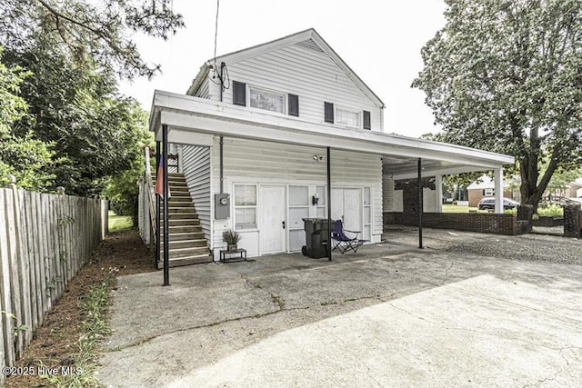 back of property with stairs and fence