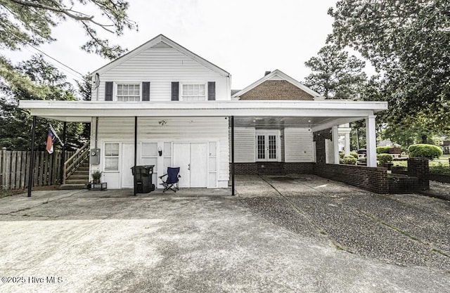 300 Moye Ave NW, Wilson, NC 27893 - back of house featuring french doors, a carport, and driveway