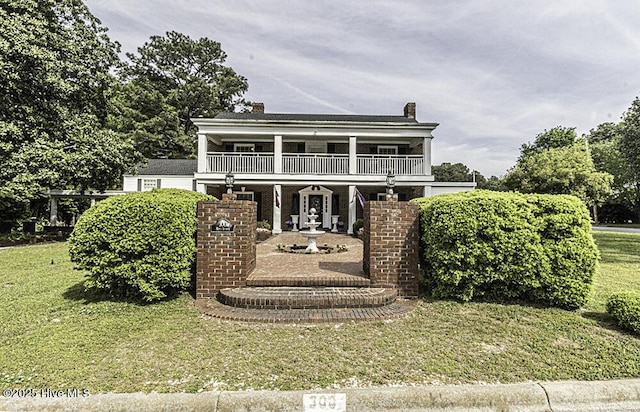300 Moye Ave NW, Wilson, NC 27893 - view of front of property featuring a front lawn, a balcony, and a chimney