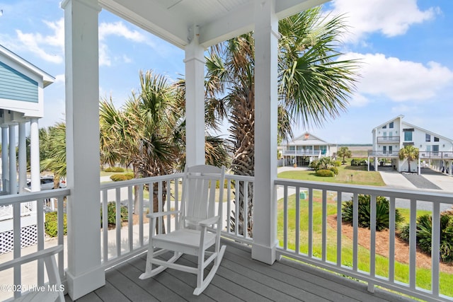 505 Caswell Beach Rd, Caswell Beach, NC 28465 - wooden deck featuring a porch