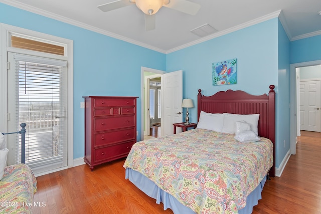 505 Caswell Beach Rd, Caswell Beach, NC 28465 - bedroom with baseboards, ornamental molding, wood finished floors, and visible vents