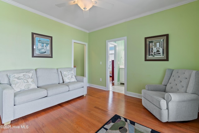 505 Caswell Beach Rd, Caswell Beach, NC 28465 - living room featuring crown molding, baseboards, ceiling fan, and wood finished floors