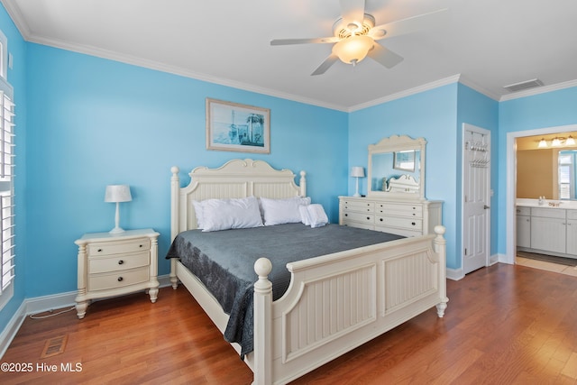 505 Caswell Beach Rd, Caswell Beach, NC 28465 - bedroom with crown molding, wood finished floors, and visible vents