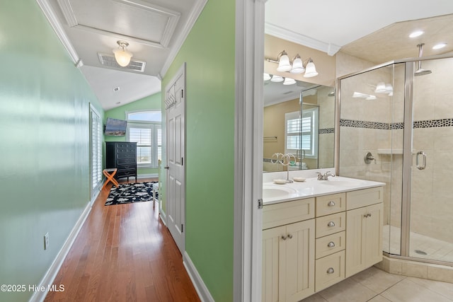 505 Caswell Beach Rd, Caswell Beach, NC 28465 - bathroom featuring a sink, crown molding, a shower stall, and visible vents