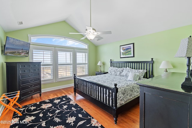 505 Caswell Beach Rd, Caswell Beach, NC 28465 - bedroom with a ceiling fan, vaulted ceiling, wood finished floors, and visible vents