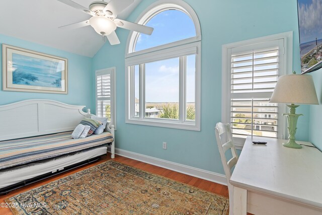 505 Caswell Beach Rd, Caswell Beach, NC 28465 - bedroom featuring baseboards, a ceiling fan, lofted ceiling, and wood finished floors