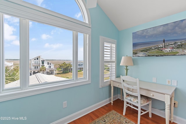 505 Caswell Beach Rd, Caswell Beach, NC 28465 - home office featuring baseboards, wood finished floors, and lofted ceiling
