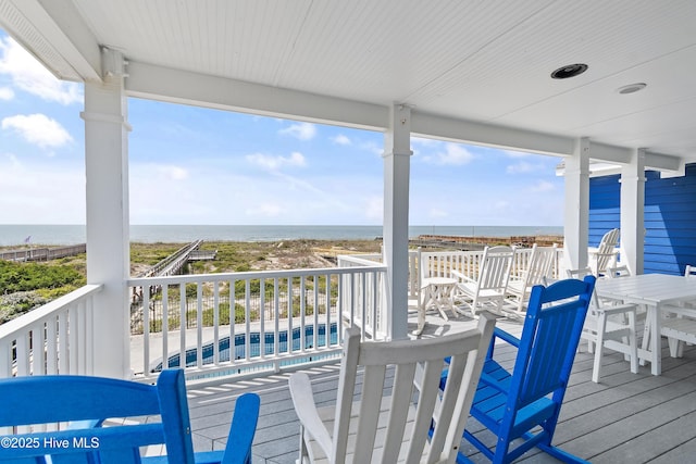 505 Caswell Beach Rd, Caswell Beach, NC 28465 - wooden terrace with a water view and a swimming pool
