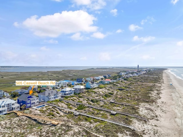 505 Caswell Beach Rd, Caswell Beach, NC 28465 - birds eye view of property featuring a beach view and a water view