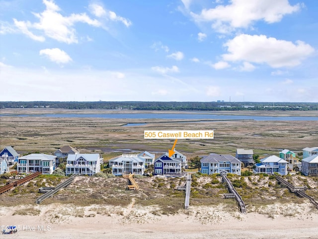 505 Caswell Beach Rd, Caswell Beach, NC 28465 - bird's eye view featuring a water view and a residential view