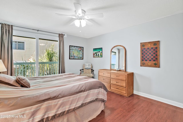 bedroom with dark wood-type flooring, baseboards, ceiling fan, and a textured ceiling
