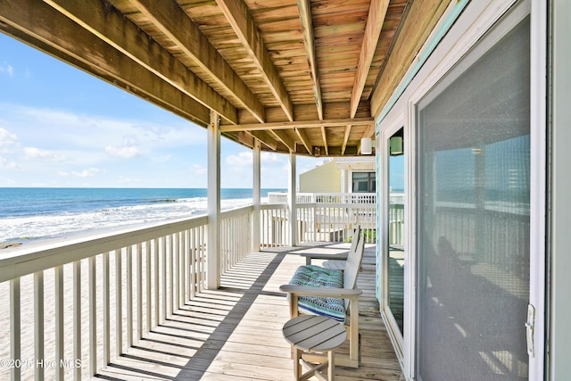 balcony featuring view of water and beach
