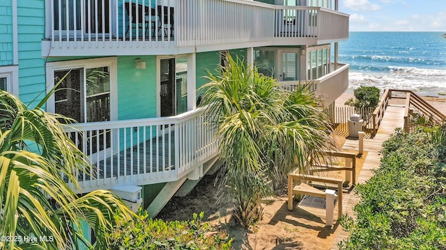 view of home's community featuring view of water and beach