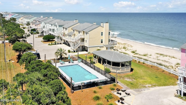 aerial view of a pool area and a nearby body of water