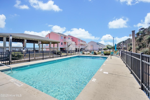 community pool with fence and a residential view