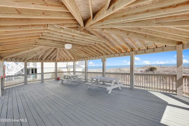 wooden deck featuring a water view and outdoor dining area