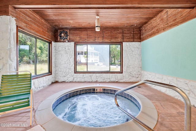 view of swimming pool featuring a hot tub