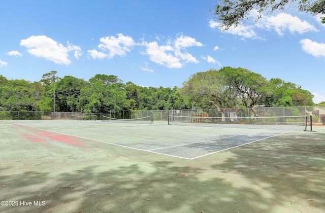 view of tennis court featuring fence