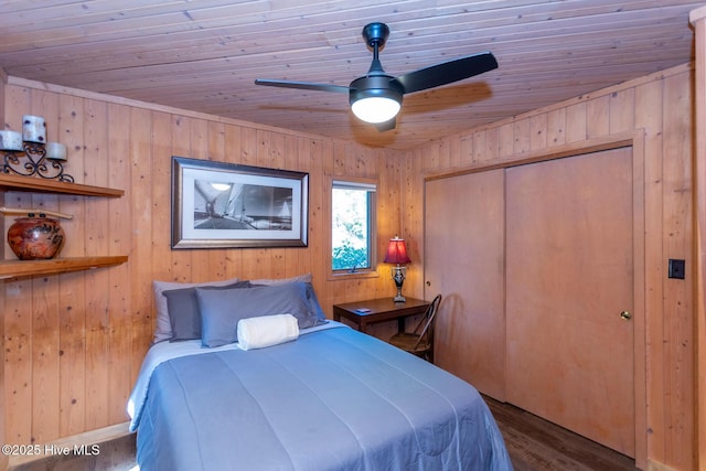 105 Tucker Ct, West End, NC 27376 - bedroom featuring wood ceiling, wood walls, wood finished floors, a closet, and ceiling fan