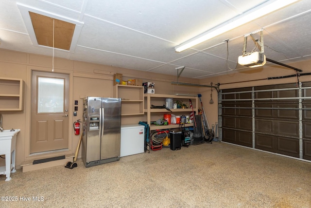 105 Tucker Ct, West End, NC 27376 - garage featuring stainless steel fridge, a garage door opener, and fridge