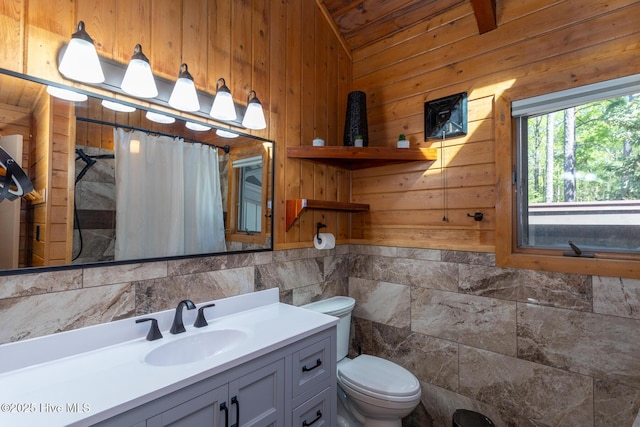 105 Tucker Ct, West End, NC 27376 - full bathroom with wooden walls, vanity, vaulted ceiling, toilet, and a shower with shower curtain