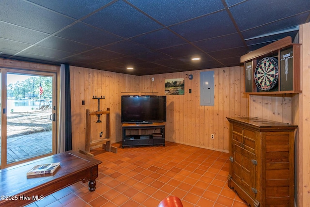 105 Tucker Ct, West End, NC 27376 - living room featuring electric panel, a drop ceiling, tile patterned floors, and wooden walls