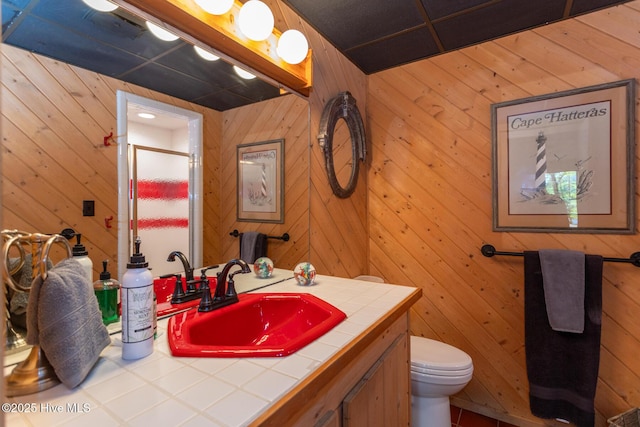 105 Tucker Ct, West End, NC 27376 - bathroom with vanity, toilet, a stall shower, and wood walls