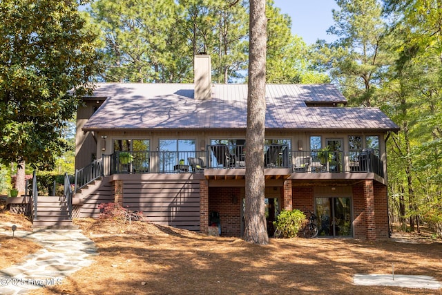 105 Tucker Ct, West End, NC 27376 - rear view of property with a chimney, brick siding, and stairway