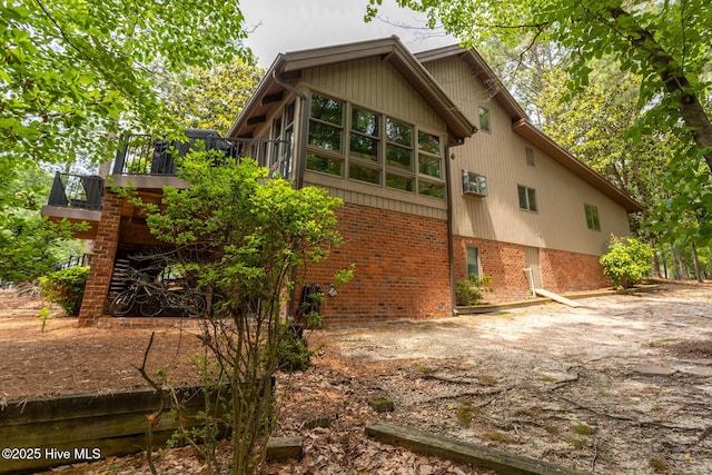 105 Tucker Ct, West End, NC 27376 - rear view of property featuring brick siding and a wooden deck