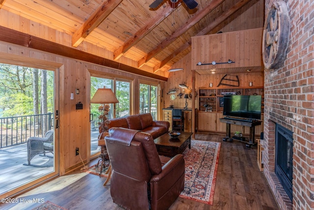 105 Tucker Ct, West End, NC 27376 - living area with wood-type flooring, a ceiling fan, plenty of natural light, wood walls, and wood ceiling with exposed beams