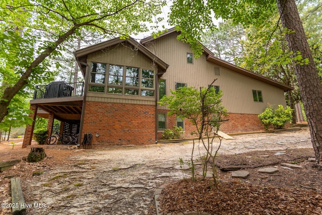 105 Tucker Ct, West End, NC 27376 - back of property with brick siding and a wooden deck