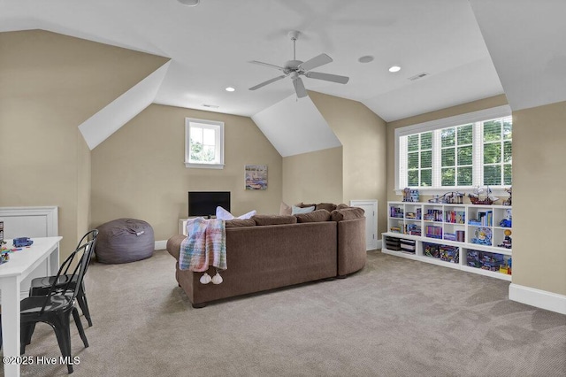 carpeted living room with a ceiling fan, baseboards, vaulted ceiling, and visible vents