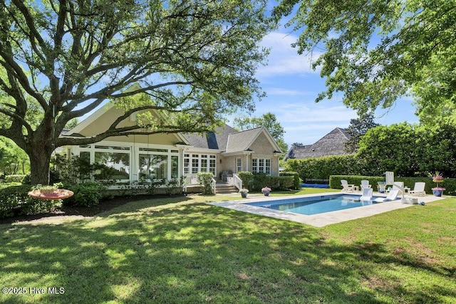 back of house with a lawn and a fenced in pool