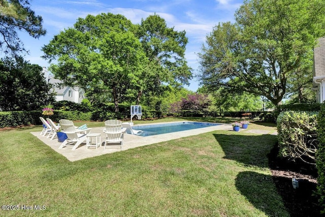 outdoor pool featuring a patio and a lawn