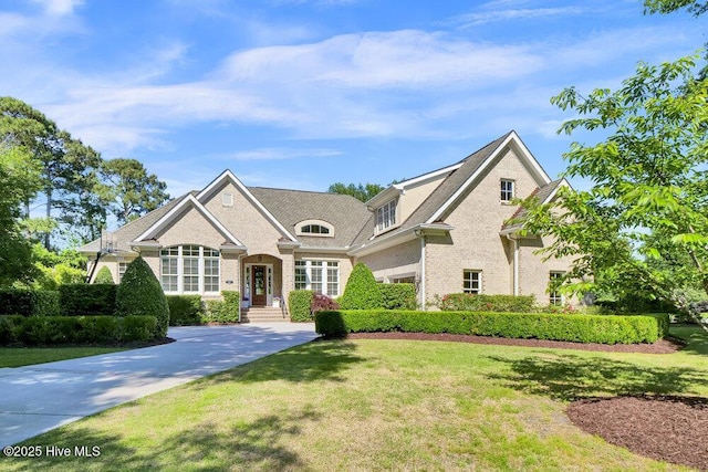 view of front of home featuring a front yard and brick siding