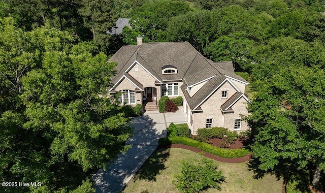 drone / aerial view with a wooded view