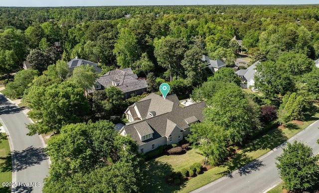 birds eye view of property featuring a wooded view